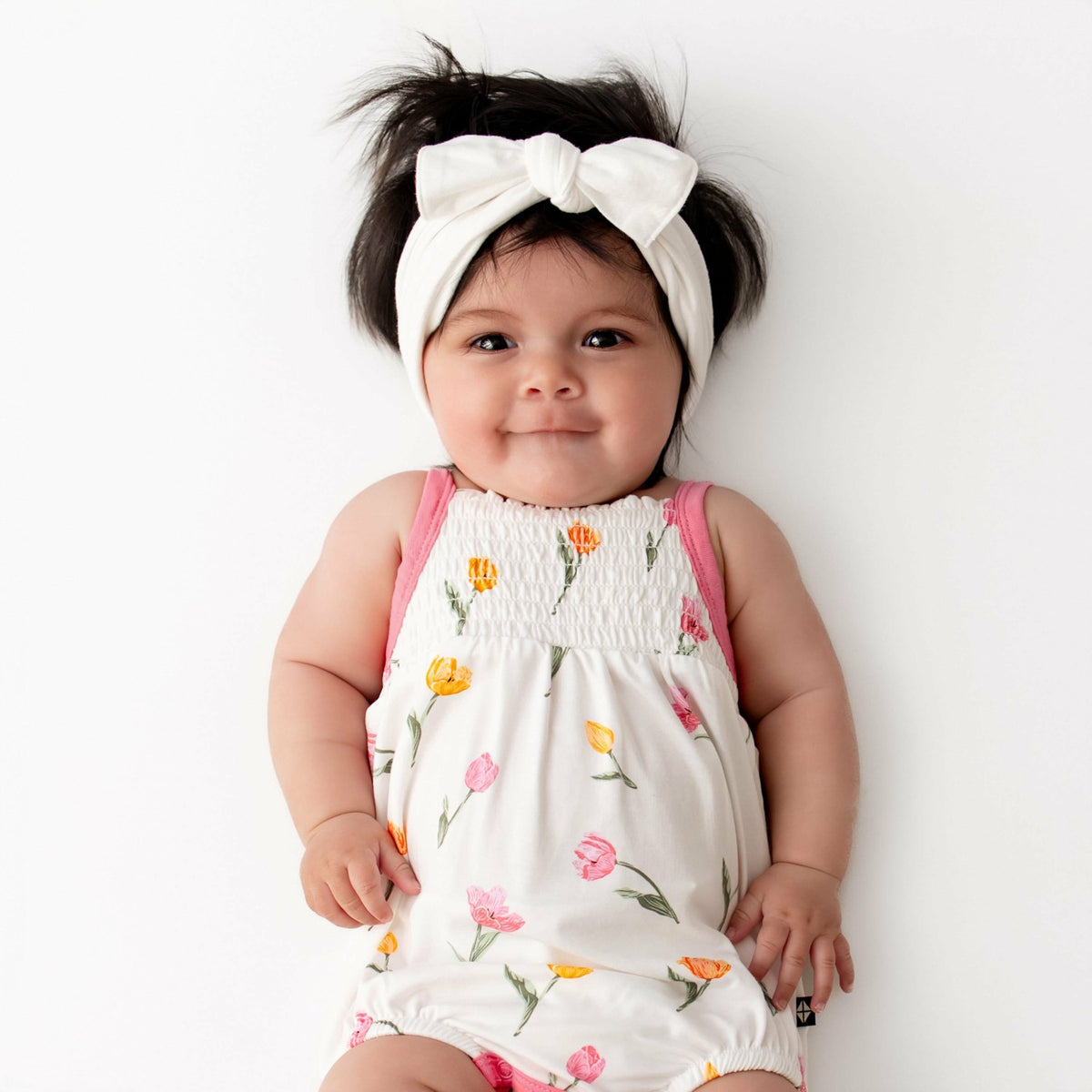Kyte Baby Smocked Bubble Romper in Tulip