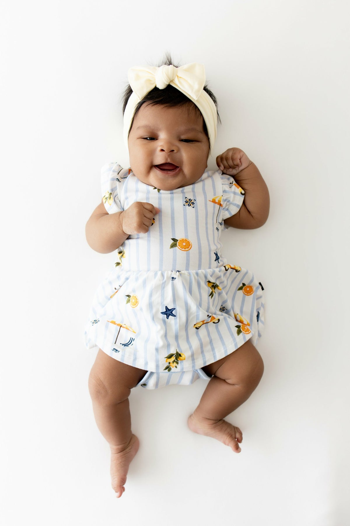 Kyte Baby Twirl Bodysuit Dress in Amalfi Coast