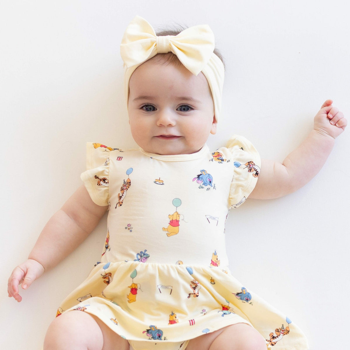 Kyte Baby Twirl Bodysuit Dress in Winnie the Pooh Celebration