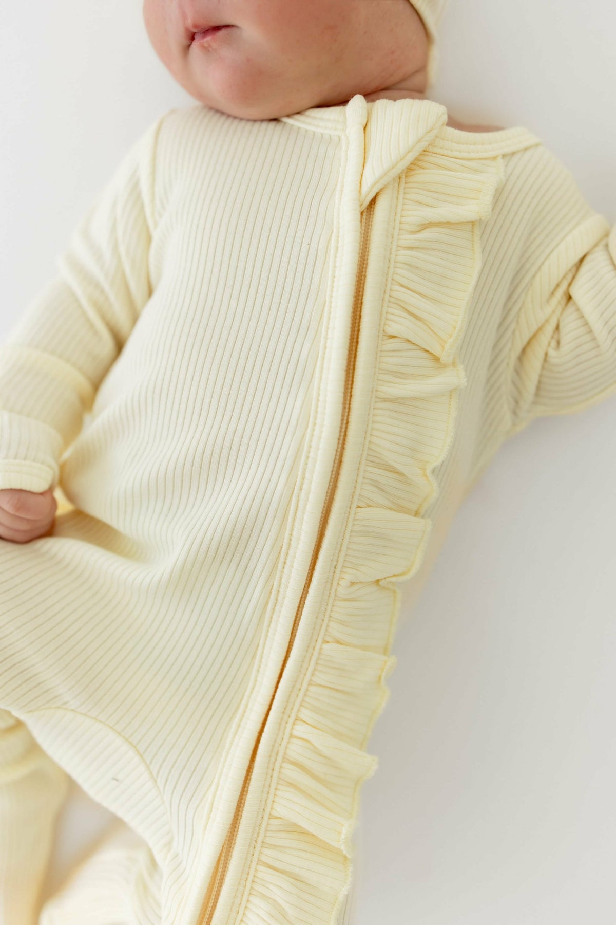 Kyte Baby Ribbed Ruffle Zipper Footie in Chamomile