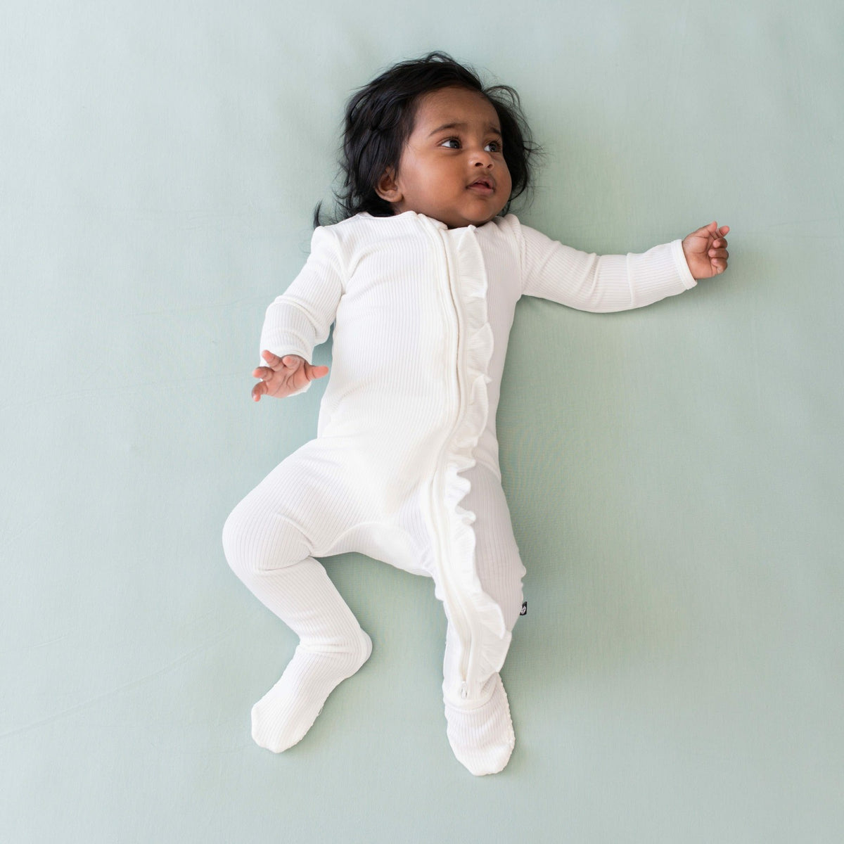 Kyte Baby Ribbed Ruffle Zipper Footie in Cloud