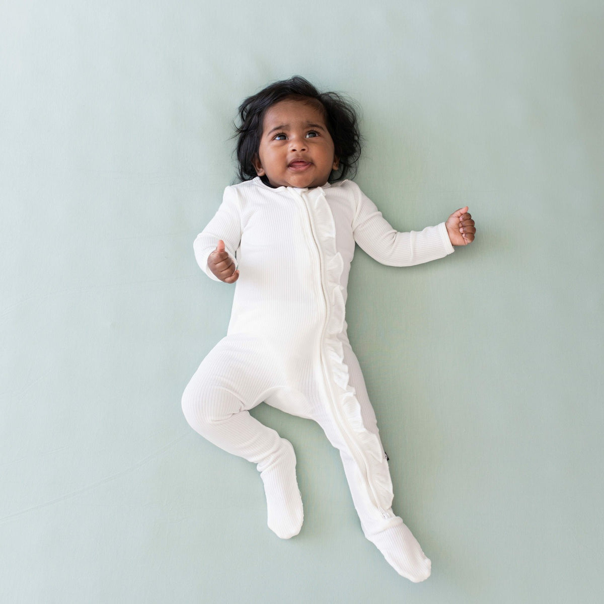 Kyte Baby Ribbed Ruffle Zipper Footie in Cloud