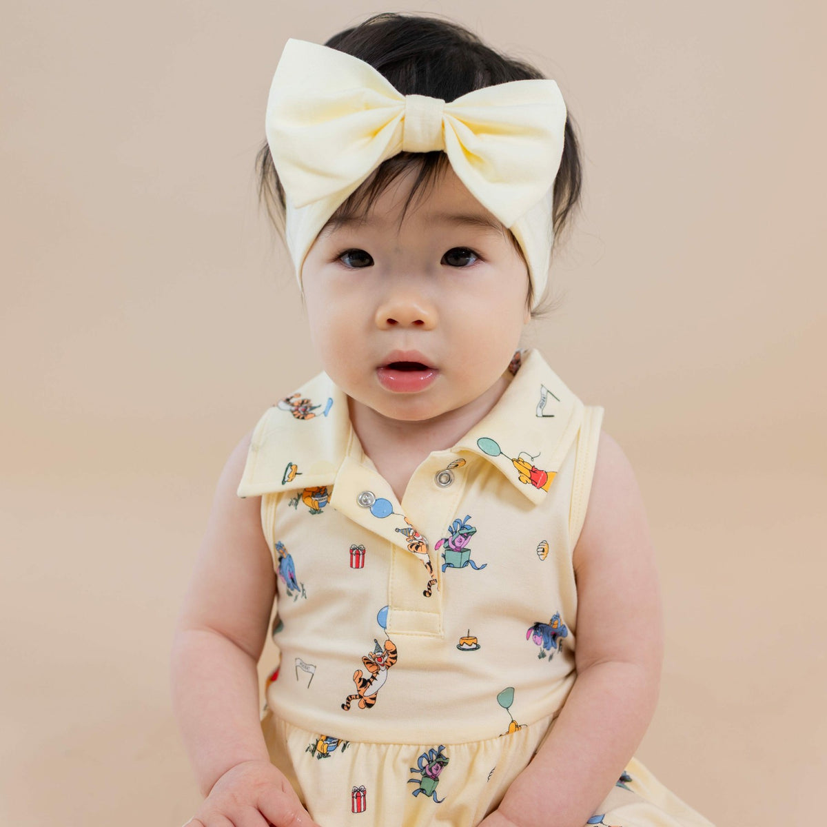 Kyte Baby Polo Bodysuit Dress in Winnie the Pooh Celebration