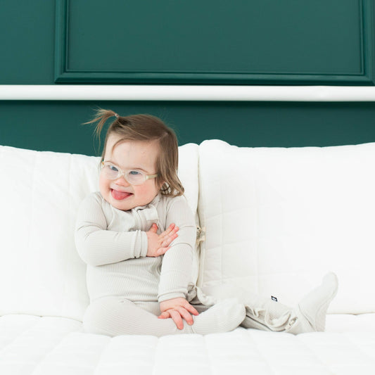 Kyte Baby Ribbed Ruffle Bamboo Zipper Footie in Oat