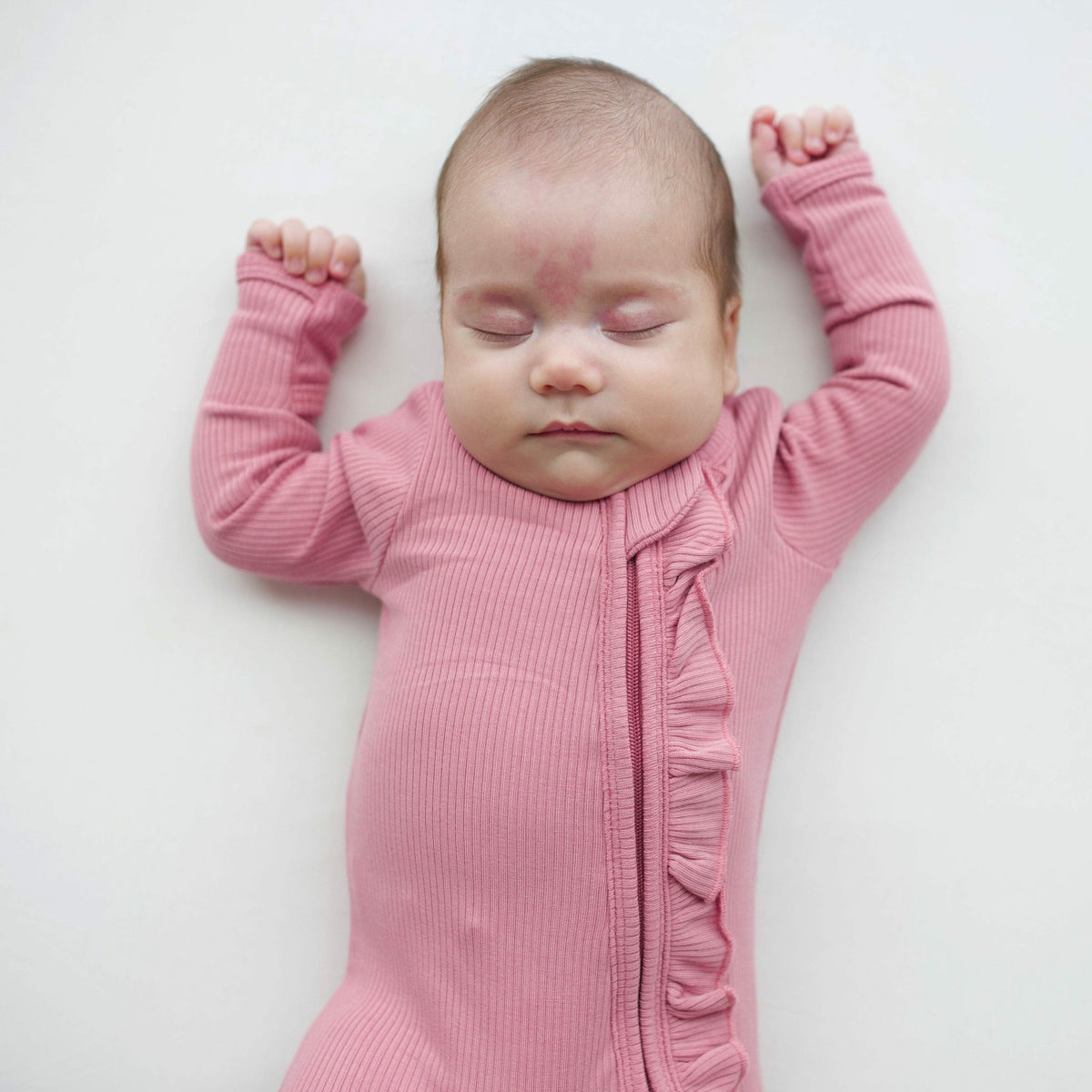 Kyte Baby Ribbed Ruffle Zipper Footie in Apple Blossom