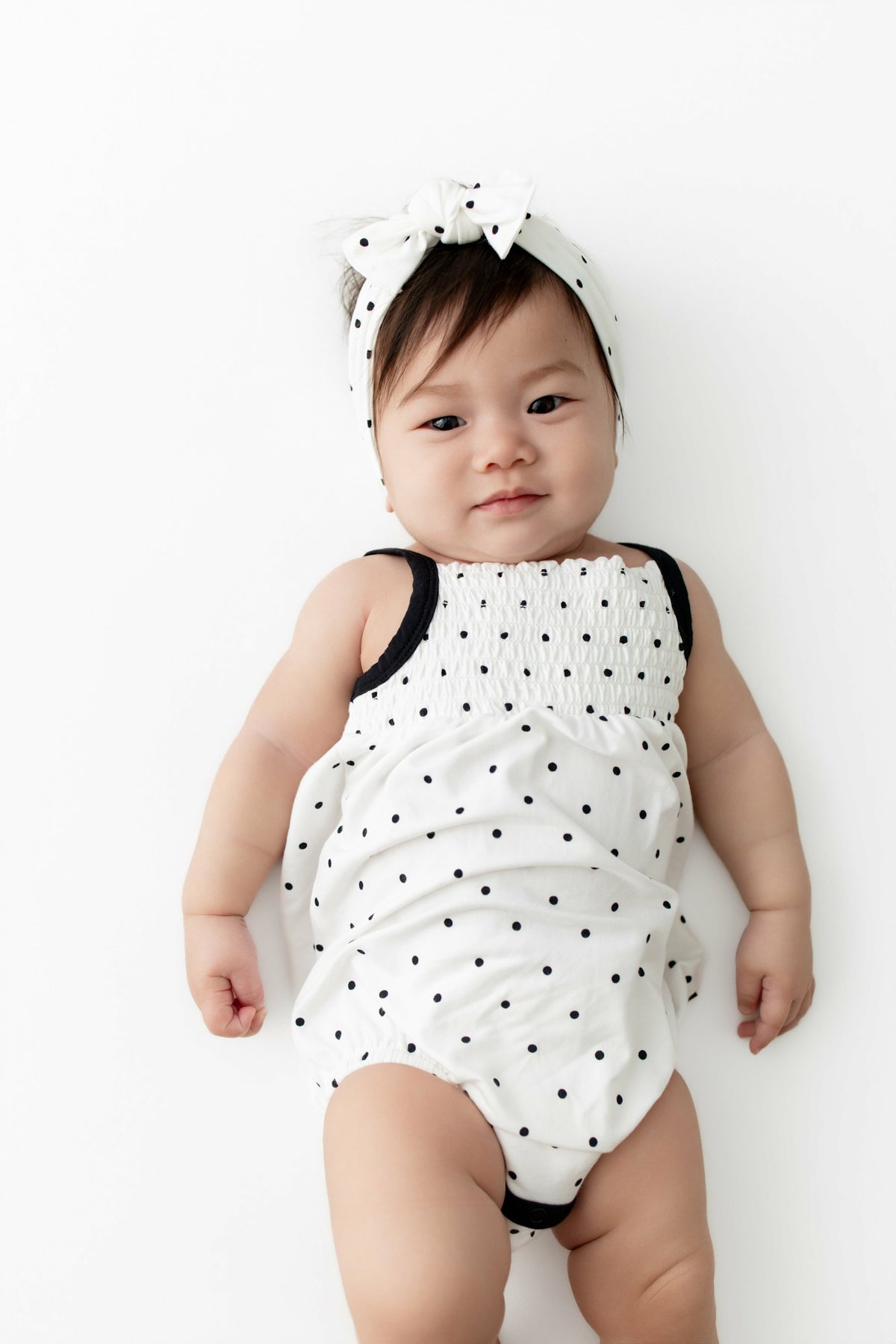 Kyte Baby Smocked Bubble Romper in Midnight Polka Dot