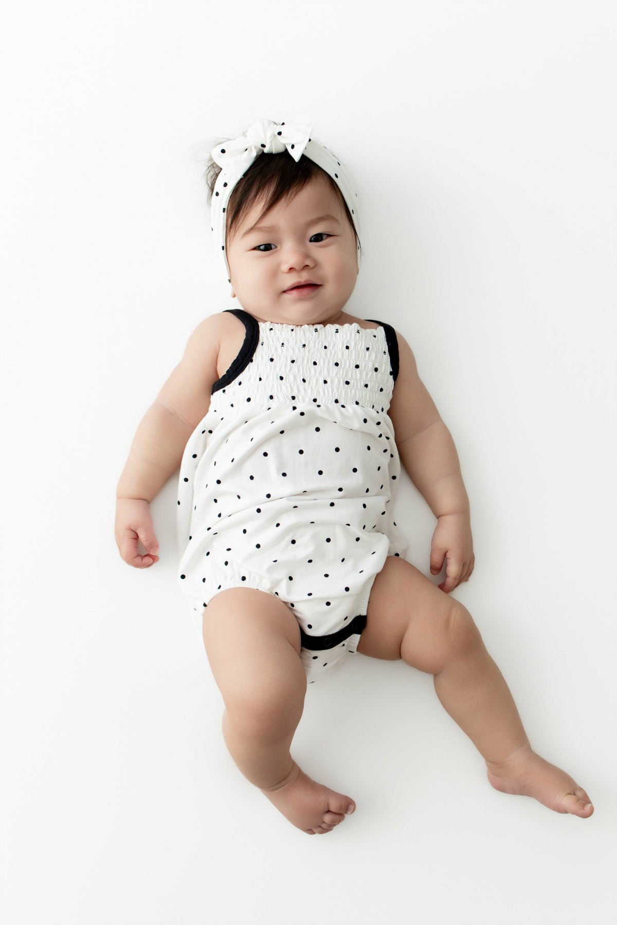 Kyte Baby Smocked Bubble Romper in Midnight Polka Dot