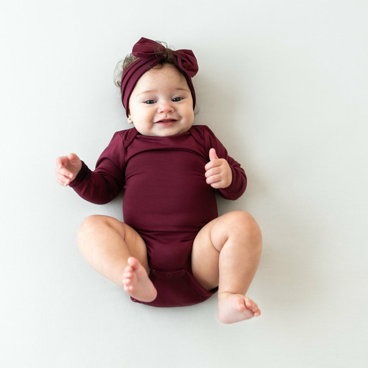 Kyte Baby Long Sleeve Bodysuit in Burgundy