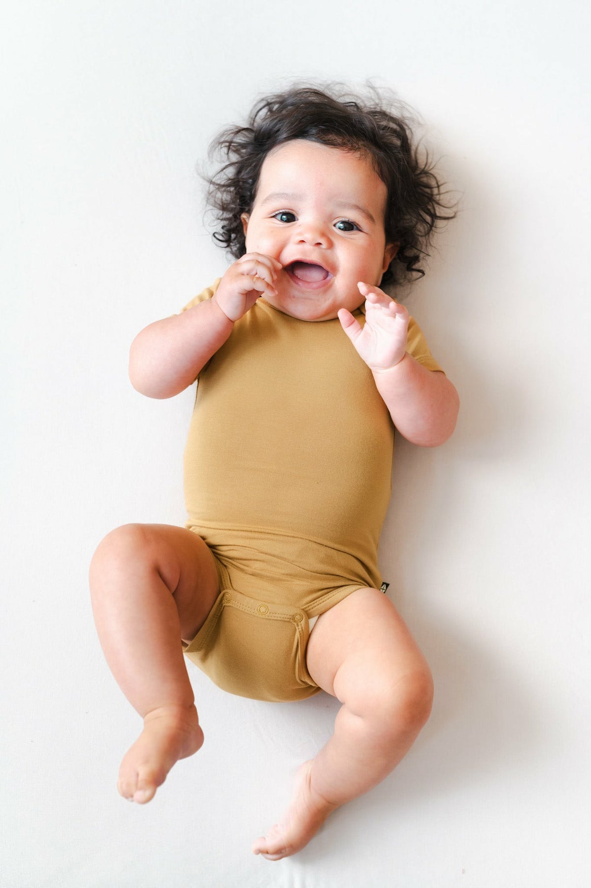 Kyte Baby Bodysuit in Ochre