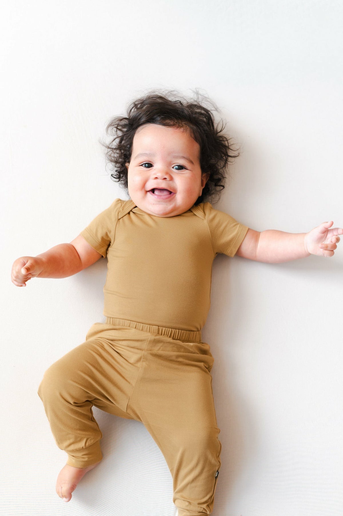 Kyte Baby Bodysuit in Ochre