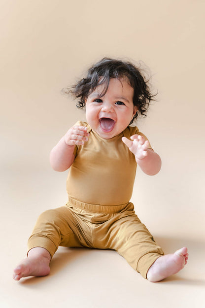 Kyte Baby Bodysuit in Ochre